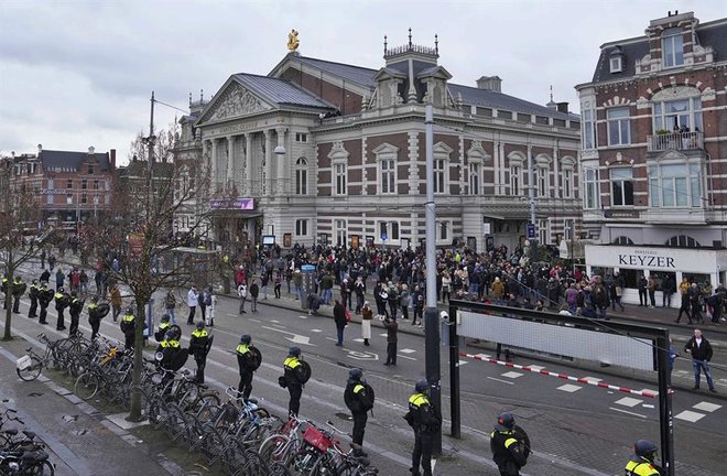 La policía nacional holandesa detiene a un manifestante mientras la gente se reunía en la Plaza de los Museos para manifestarse contra las medidas de bloqueo impuestas por el gobierno. / EFE/EPA/PHIL NIJHUIS
