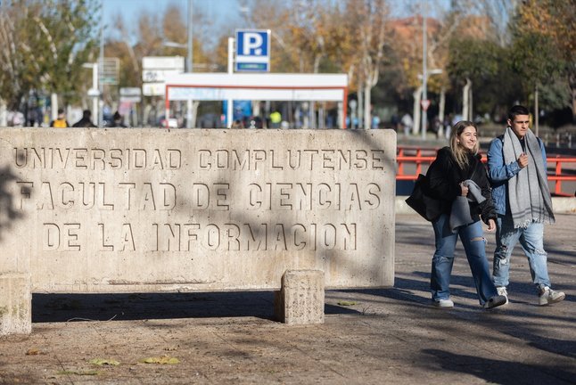 Dos personas caminan junto a la Facultad de Ciencias de la Información, en la Universidad Complutense de Madrid. Eduardo Parra / Archivo