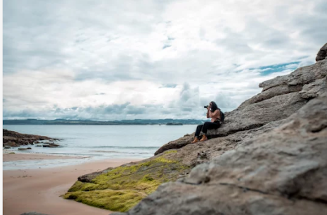 Una turista hace una fotografía en una playa de Cantabria. /A.E.